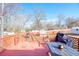 Outdoor wooden deck overlooking the backyard with a table and grill at 1724 Hill Ne St, Conyers, GA 30012