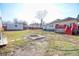 Spacious backyard with a shed, mature trees, and a fire pit area at 1724 Hill Ne St, Conyers, GA 30012