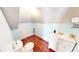 A quaint bathroom featuring wood floors, a toilet, and a vanity with modern fixtures at 1724 Hill Ne St, Conyers, GA 30012