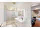 Bright bathroom featuring a glass shower, a sleek, lighted mirror, and a white vanity with modern fixtures at 1724 Hill Ne St, Conyers, GA 30012