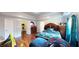A comfortable bedroom boasts a decorative bed frame, wood floors, and ample natural light from a window at 1724 Hill Ne St, Conyers, GA 30012
