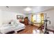 A bedroom with a bed, dresser, wood floors, exercise equipment, and plenty of natural light from the windows at 1724 Hill Ne St, Conyers, GA 30012
