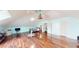 Expansive bonus room featuring modern decor, beautiful hardwood floors, and vaulted ceiling at 1724 Hill Ne St, Conyers, GA 30012