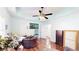 A bright, expansive living room features wood floors and soft, oversized chairs under a unique ceiling with fan at 1724 Hill Ne St, Conyers, GA 30012