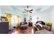 An inviting living room featuring wood floors, soft, oversized chairs, and a unique ceiling fan with lighting at 1724 Hill Ne St, Conyers, GA 30012