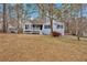 Single-story home with light-blue siding, front porch and dormant winter lawn at 305 Sadler Dr, Douglasville, GA 30134