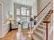 Bright living room with hardwood floors and staircase with carpeted steps at 525 Tilbury Dr, Suwanee, GA 30024