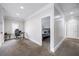 Hallway area features carpeted floors, view of office and a bedroom, creating a comfortable and connected space at 1363 Summer Lane Se Dr, Atlanta, GA 30316
