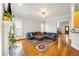 Spacious living room featuring hardwood floors, fireplace, and a large sectional sofa at 1363 Summer Lane Se Dr, Atlanta, GA 30316