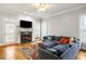 Comfortable living room with fireplace, hardwood floors, and a large sectional sofa at 1363 Summer Lane Se Dr, Atlanta, GA 30316
