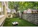 Private backyard with stone walls, offering a peaceful retreat for outdoor activities at 605 Park Ne Dr, Atlanta, GA 30306