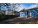 Backyard view of a blue home with a white door, window, and a wood fence at 884 Mcdaniel Sw St, Atlanta, GA 30310