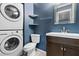 Bathroom with stacked washer and dryer unit, vanity with sink, and modern fixtures at 2412 Peachwood Circle Northeast Ne Cir # 3, Atlanta, GA 30345
