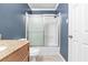 Comfortable bathroom featuring a shower with sliding doors and blue accent wall at 2412 Peachwood Circle Northeast Ne Cir # 3, Atlanta, GA 30345