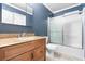 Bathroom with granite countertop vanity, shower with sliding door and blue accent wall at 2412 Peachwood Circle Northeast Ne Cir # 3, Atlanta, GA 30345
