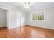 Bedroom with hardwood floors, ceiling fan, and large window to let in natural light at 2412 Peachwood Circle Northeast Ne Cir # 3, Atlanta, GA 30345
