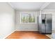 Bright dining area features hardwood floors, a large window, and a stainless steel refrigerator at 2412 Peachwood Circle Northeast Ne Cir # 3, Atlanta, GA 30345