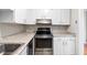 A kitchen featuring stainless steel stove, dishwasher, white cabinets and laminate countertops at 2412 Peachwood Circle Northeast Ne Cir # 3, Atlanta, GA 30345