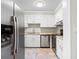 Well-maintained kitchen with white cabinets and stainless steel appliances, including fridge and dishwasher at 2412 Peachwood Circle Northeast Ne Cir # 3, Atlanta, GA 30345