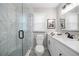 Modern bathroom with a glass enclosed shower and white marble tile and vanity at 2485 Brentwood Rd, Decatur, GA 30032