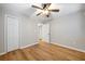 This bedroom features stylish wood flooring, a ceiling fan, and a closet with double doors at 2485 Brentwood Rd, Decatur, GA 30032