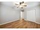 This bedroom features stylish wood flooring, a ceiling fan, and a closet with double doors at 2485 Brentwood Rd, Decatur, GA 30032