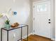 Bright entryway featuring a modern console table, stylish decor, and a door with glass panes at 2485 Brentwood Rd, Decatur, GA 30032