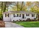 Inviting home with a freshly painted exterior, neatly kept landscaping, and a paved driveway at 2485 Brentwood Rd, Decatur, GA 30032