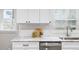 Kitchen featuring white marble countertops, white cabinets, and a stainless steel dishwasher at 2485 Brentwood Rd, Decatur, GA 30032