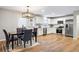 Kitchen area featuring stainless steel appliances and white cabinets and dining area with a black table at 2485 Brentwood Rd, Decatur, GA 30032