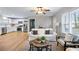 Open concept living room and kitchen with wood floors and lots of natural light at 2485 Brentwood Rd, Decatur, GA 30032