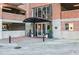 Stylish building entrance features brickwork and decorative plants, leading to a modern glass entryway at 3235 Roswell Ne Rd # 919, Atlanta, GA 30305