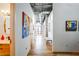 Bright hallway with modern art, wood floors, and exposed ductwork on the ceiling at 3235 Roswell Ne Rd # 919, Atlanta, GA 30305