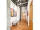 Hallway with wood floors, art, bench and concrete beams with exposed ductwork at 3235 Roswell Ne Rd # 919, Atlanta, GA 30305