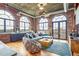 Expansive living room featuring exposed brick, hardwood floors, and large arched windows at 3235 Roswell Ne Rd # 919, Atlanta, GA 30305