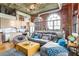 Open-concept living space with exposed brick, modern kitchen, and ample natural light at 3235 Roswell Ne Rd # 919, Atlanta, GA 30305