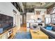 Open concept kitchen and living room with exposed ductwork and exposed brick at 3235 Roswell Ne Rd # 919, Atlanta, GA 30305
