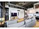 Spacious living room with a gray sofa, modern entertainment center, and an open floor plan to the kitchen at 3235 Roswell Ne Rd # 919, Atlanta, GA 30305