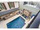 An aerial view of a backyard pool with a kitchen, seating, and a water feature at 301 Abercorn Sq, Peachtree City, GA 30269
