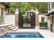 A gated entrance and lush landscaping surround a backyard pool, creating a private outdoor oasis at 301 Abercorn Sq, Peachtree City, GA 30269