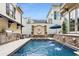A beautifully landscaped backyard with a pool, outdoor kitchen, and multiple seating areas, perfect for outdoor entertaining at 301 Abercorn Sq, Peachtree City, GA 30269