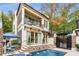 A charming backyard with a pool, a two-story home, and lush landscaping, ideal for outdoor living and entertaining at 301 Abercorn Sq, Peachtree City, GA 30269