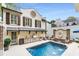 A beautiful backyard with a pool, outdoor kitchen, and a charming seating area, ideal for outdoor living at 301 Abercorn Sq, Peachtree City, GA 30269