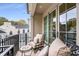 Relaxing balcony with seating area and wrought iron railing overlooking neighborhood at 301 Abercorn Sq, Peachtree City, GA 30269