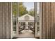 View from a balcony with patterned curtains, outdoor seating, and a view of the house at 301 Abercorn Sq, Peachtree City, GA 30269