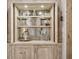 Bar area with mirrored backsplash, glassware display, and custom wood cabinetry at 301 Abercorn Sq, Peachtree City, GA 30269