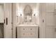 Bright bathroom with a modern vanity, marble countertop, sconces, and elegant mirror at 301 Abercorn Sq, Peachtree City, GA 30269