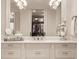 Elegant bathroom vanity with white cabinets, marble countertops, and decorative mirrors at 301 Abercorn Sq, Peachtree City, GA 30269