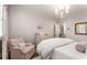Bright bedroom with a comfortable armchair, wooden floors, and a soft, inviting bed at 301 Abercorn Sq, Peachtree City, GA 30269