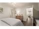 Bright bedroom with hardwood floors, a dresser, and a comfortable bed with white duvet at 301 Abercorn Sq, Peachtree City, GA 30269